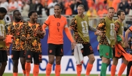 From L: Netherlands' midfielder #26 Quinten Timber, defender #04 Virgil van Dijk and forward #09 Wout Weghorst celebrate after winning the 2026 World Cup Group F football match between Tunisia and the Netherlands. (Photo by Juan Mabromata / AFP)