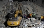 Rescue teams operate heavy machinery at the site of a collapsed building in Caracas on June 25, 2026, following earthquakes. (Photo by Juan BARRETO / AFP)