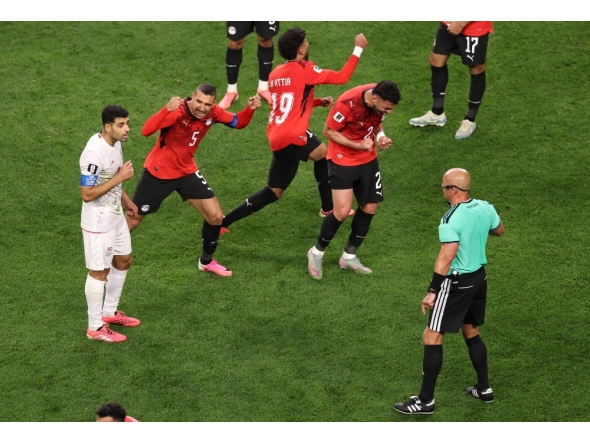 Egypt players react as referee Szymon Marciniak calls an offside violation and overturns the goal by Shoja Khalilzadeh #4 of IR Iran following a VAR review. Stu Forster/Getty Images/AFP