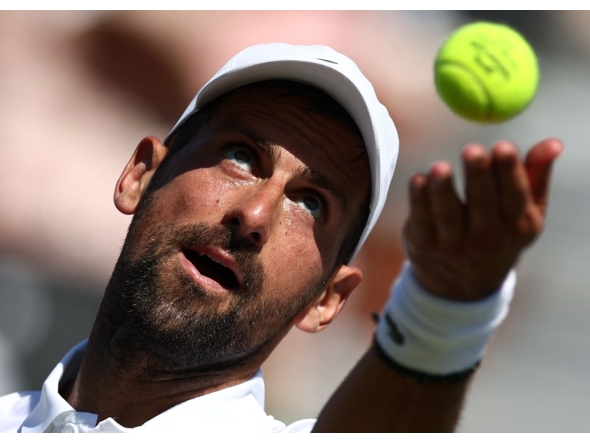Serbia's Novak Djokovic throws the ball to serve against US player Tommy Paul during their men's singles match on day four of the Giorgio Armani Tennis Classic tournament at the Hurlingham Club in London on June 26, 2026. (Photo by Henry Nicholls / AFP)
