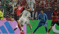 Austria's forward #14 Sasa Kalajdzic heads the ball to score his team's third goal. (Photo by Juan Mabromata / AFP)