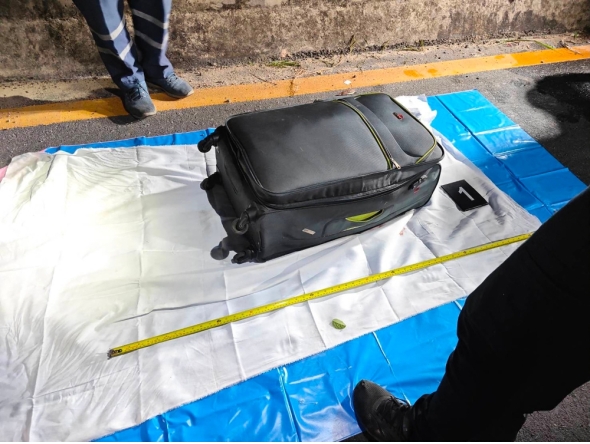 In this handout photo taken in Pattaya on June 27, 2026 and provided by Pattaya City Police Station on June 29, police officers measure a suitcase after the suspected murder of a 17-year-old Thai girl. (Photo by Handout / Pattaya City Police Station / AFP)