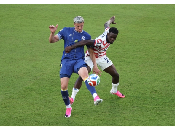 Folarin Balogun #20 of the United States fouls Tarik Muharemovic #4 of Bosnia and Herzegovina in Santa Clara, California. Michael Steele/Getty Images/AFP 