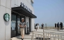 A visitor walks past a Starbucks store offering a view of North Korea at a South Korean observation deck at Aegibong Peace Ecopark in Gimpo on July 1, 2026. Photo by Jung Yeon-je / AFP