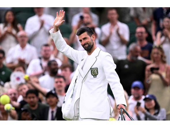Serbia's Novak Djokovic waves as he leaves the court after winning Greece's Stefanos Tsitsipas during their men's singles second round tennis match on the third day of the 2026 Wimbledon Championships at The All England Lawn Tennis and Croquet Club in Wimbledon, southwest London, on July 1, 2026. (Photo by Kirill KUDRYAVTSEV / AFP)
