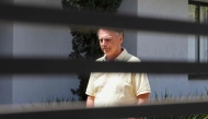 (FILES) Former Brazilian President Jair Bolsonaro gestures from his residence in Brasilia on September 3, 2025. (Photo by Sergio Lima / AFP)