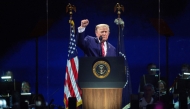 US President Donald Trump raises his fist while speaking at 