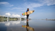 This photograph taken on June 19, 2026, shows Bangladeshi surfer Fatima Akhter posing for a photograph before a surfing session along a beach in the Bay of Bengal in Cox's Bazar. Photo by Munir Uz Zaman / AFP