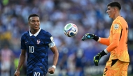 France's forward #10 Kylian Mbappe celebrates past Paraguay's goalkeeper #12 Orlando Gill after winning the 2026 World Cup round of 16 football match between Paraguay and France at the Philadelphia Stadium in Philadelphia on July 4, 2026. (Photo by MAURO PIMENTEL / AFP)