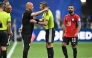 Egypt's head coach Hossam Hassan speaks with French referee Francois Letexier as Egypt's forward #10 Mohamed Salah looks on. (Photo by Roberto Schmidt / AFP)