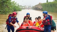 Rescue workers evacuate flood-affected students in Guigang, in China's southern Guangxi region, on July 8, 2026. (Photo by CN-STR / AFP)