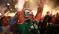 A masked Mexican football fan reacts as they watch the 2026 FIFA World Cup Round of 16 football match between Mexico and England at the Angel of Independence in Mexico City on July 5, 2026. (Photo by Claudia Rosel / AFP)