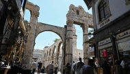 Shoppers walk through an old market area near the Umayyad Mosque in Damascus on July 9, 2026. (Photo by Louai Beshara / AFP)
