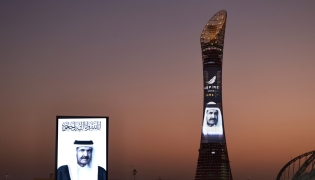 Portraits of Father Amir across Qatar’s iconic landmarks