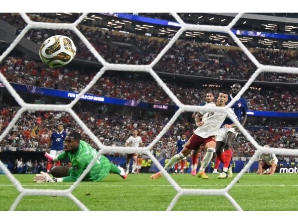 Spain's defender #12 Pedro Porro shoots and scores his team's second goal during the 2026 World Cup football tournament semi-final match between France and Spain at the Dallas Stadium in Arlington on July 14, 2026. (Photo by MAURO PIMENTEL / AFP)