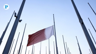 Qatar’s flag at half mast at Flag Plaza on Doha Corniche