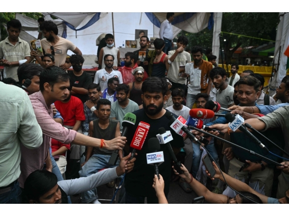 Cockroach Janta Party (CJP) founder Abhijeet Dipke speaks to the media during a protest demanding the resignation of India's Education Minister Dharmendra Pradhan over alleged NEET exam irregularities, in New Delhi on July 21, 2026. (Photo by Arun Sankar / AFP)