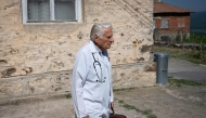 Dr. Apostolov, 90, a general practitioner, leaves his consulting room to visit a patient in the village of Skrat, in the foothills of the Belasitsa Mountains on July 15, 2026. (Photo by Nikolay Doychinov / AFP)