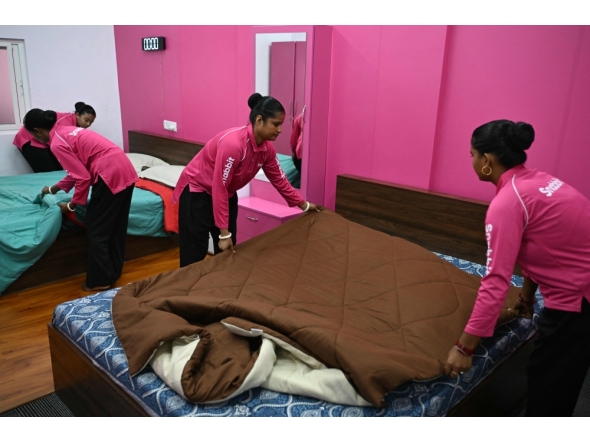 This photograph taken on June 22, 2026 shows employees of the on-demand home-services platform Snabbit, making beds at the company's training centre in Bengaluru. (Photo by Idrees Mohammed / AFP)
 