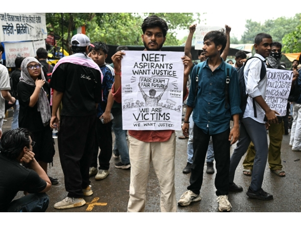 A Cockroach Janta Party (CJP) supporter holds a placard at Jantar Mantar in New Delhi on July 22, 2026. (Photo by Sajjad Hussain / AFP)