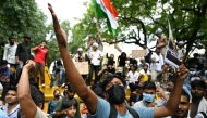 A Cockroach Janta Party (CJP) supporter shouts slogans at Jantar Mantar in New Delhi on July 23, 2026. (Photo by Sajjad Hussain / AFP)