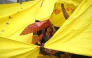 A school girl takes shelter under an umbrella at Jantar Mantar in New Delhi on July 24, 2026. (Photo by Arun Sankar / AFP)
 