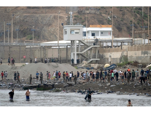 Migrants swim through the waters close to border the with Morocco to enter Spain's north Africa's Ceuta enclave on July 31, 2026. Photo by JORGE GUERRERO / AFP