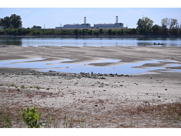 :The dried-up Danube riverbed is pictured with the Paks power plant at the background, near Dunaszentbenedek, close to Paks town on July 31, 2026. (Photo by Attila KISBENEDEK / AFP)
