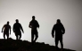 Migrants walk towards the Fnideq region in northern Morocco after leaving Spain's North African enclave of Ceuta near the town of Fnideq, on the Morocco-Spain border, following an attempted to cross at the Bab Sebta border crossing, on the Morocco- (Photo by Abdel Majid BZIOUAT / AFP)