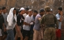 A Spanish soldier controls a group of migrants on their way back towards the Moroccan border, following their illegal crossing into the Spanish enclave of Ceuta, on August 1, 2026 (Photo by JORGE GUERRERO / AFP)