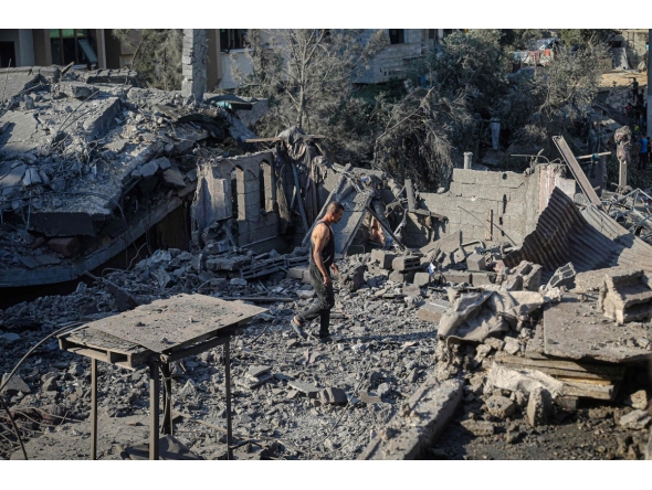 A displaced Palestinian man walks across the debris of buildings destroyed in Israeli attacks in Deir al-Balah, central Gaza Strip on August 1, 2026. (Photo by Eyad Baba / AFP)