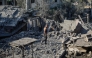 A displaced Palestinian man walks across the debris of buildings destroyed in Israeli attacks in Deir al-Balah, central Gaza Strip on August 1, 2026. (Photo by Eyad Baba / AFP)