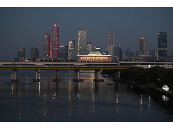 Buildings are seen behind a bridge over the Han River in Seoul on August 1, 2026. (Photo by Greg Baker / AFP)