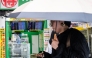 A woman walks past a display showing currency rates at a money exchange in Shinjuku district in Tokyo on July 24, 2026. Photo by ANDREW CABALLERO-REYNOLDS / AFP