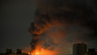 Smoke rises above residential buildings following an air attack in Kyiv on August 1, 2026. (Photo by Eugene Kotenko / AFP)
 
