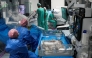 This photo taken on July 3, 2026 shows surgeons and nurses using the new Da Vinci 5 robotic-assisted surgical system while performing surgery, at St Bartholomew's Hospital in London. (Photo by Carlos Jasso / AFP)