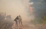 Volunteers and firefighters work to extinguish a wildfire in the Veniza area, west of Athens, in the Viotia region, on August 2, 2026. Photo by Aris Oikonomou / AFP