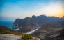 A photo of a beach, sea, and mountains in Oman