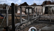 This picture shows burnt houses in Le Porge, southwestern France, on August 3, 2026, after authorities allowed residents to return to their homes. (Photo by Christophe ARCHAMBAULT / AFP)