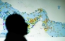 (Files) A photo illustration taken in Nicosia on May 4, 2026, shows a person in front of a large screen displaying vessel movements in the Strait of Hormuz on a ship-tracking website. (Photo by AFP)