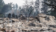 The rubble of a burned out residential home smolders in the Balboa neighborhood of Spokane, Washington, on August 2, 2026. Photo by Erick Doxey / AFP