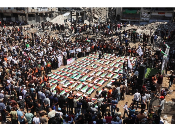 Palestinian mourners attend the funeral of members of the Abu Sharia and Al-Hassaina families, whose remains were recently recovered from the rubble of residential buildings in the al-Sabra neighbourhood which were struck by Israeli bombardments in November 2023, in Gaza City on August 4, 2026. (Photo by Omar AL-QATTAA / AFP)