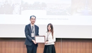 A Qatar Museums representative receives the award from an official during the ceremony in Busan, Republic of Korea.