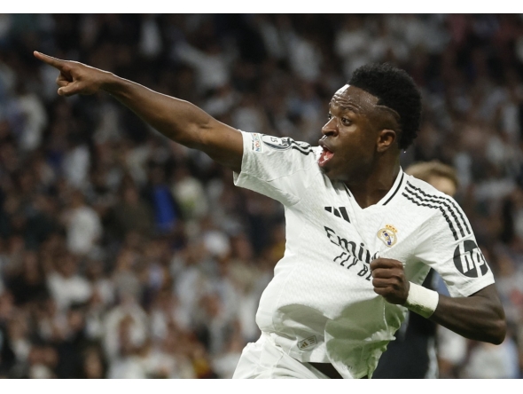 (FILES) Real Madrid's Brazilian forward #07 Vinicius Junior celebrates scoring his team's first goal during the UEFA Champions League quarter final second leg football match between Real Madrid CF and Arsenal at Santiago Bernabeu Stadium in Madrid on April 16, 2025. (Photo by Pierre-Philippe MARCOU / AFP)
