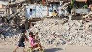 Palestinian children play near the rubble of destroyed buildings in Gaza City on August 2, 2026. Photo by OMAR AL-QATTAA / AFP