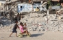 Palestinian children play near the rubble of destroyed buildings in Gaza City on August 2, 2026. Photo by OMAR AL-QATTAA / AFP