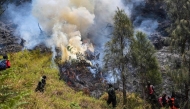 Firefighters battle a wildfire in the Bromo Tengger Semeru National Park near Mount Bromo in Probolinggo, East Java province on August 6, 2026. (Photo by JUNI KRISWANTO / AFP)
