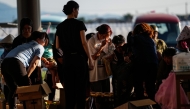 People receive relief materials at a shelter in Kumamoto Prefecture, Japan, July 30, 2026. (Xinhua/Jia Haocheng)