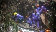 Rescuers sift through rubble as they search for survivors after a rain-drenched mountainside collapsed on several houses in Baguio City, north of Manila, on August 10, 2026. Photo by JJ LANDINGIN / AFP