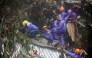 Rescuers sift through rubble as they search for survivors after a rain-drenched mountainside collapsed on several houses in Baguio City, north of Manila, on August 10, 2026. Photo by JJ LANDINGIN / AFP